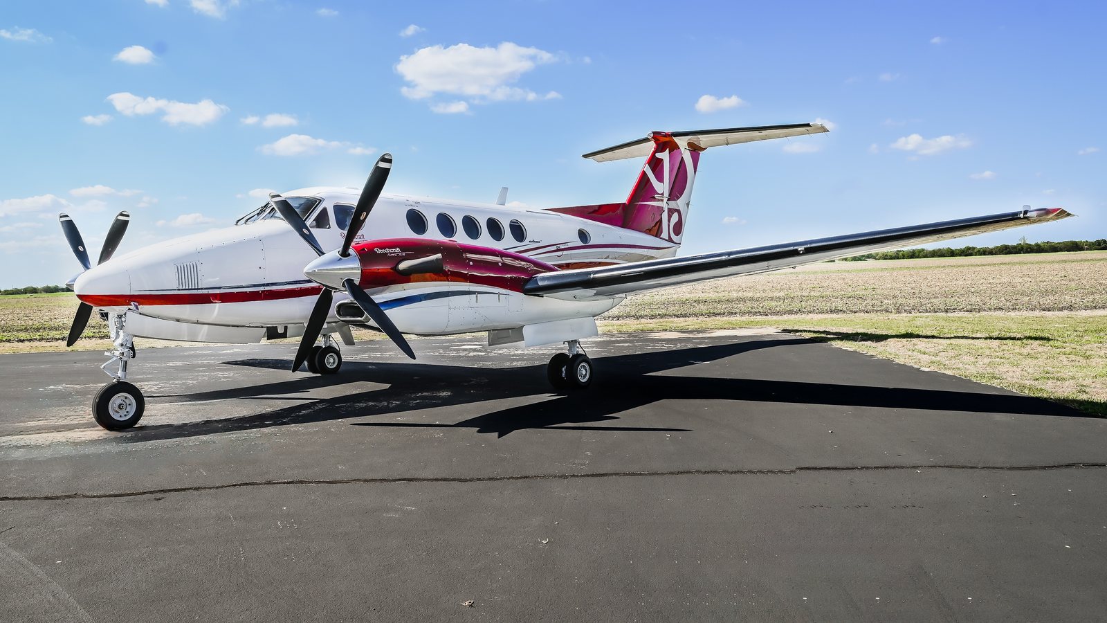 King Air in white and crimson livery on the ramp
