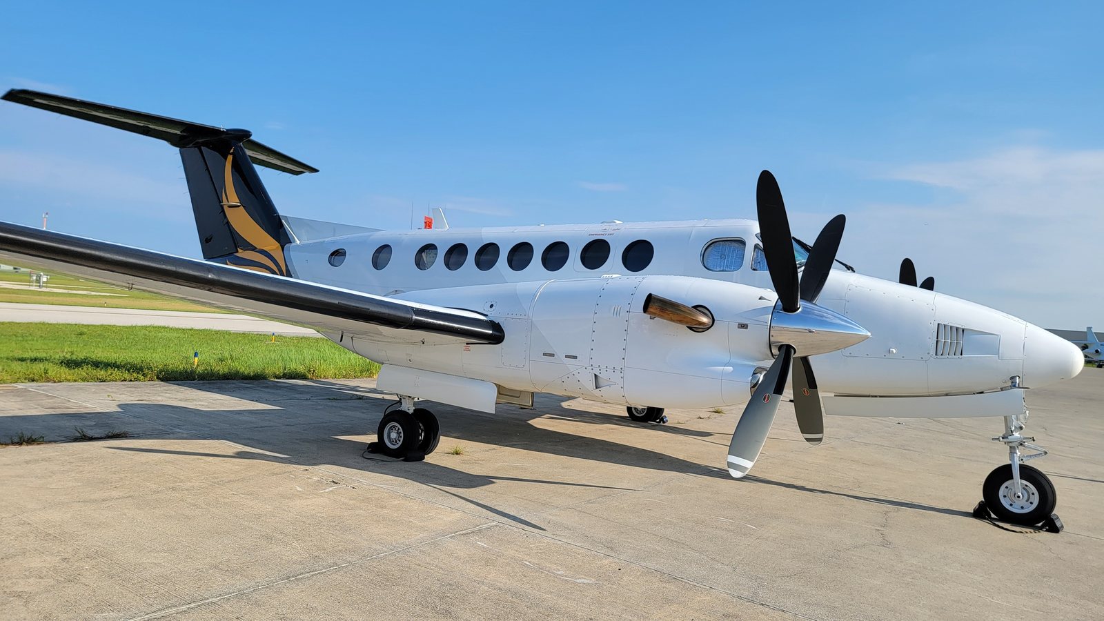 White King Air 350 with a gold tail on the ramp